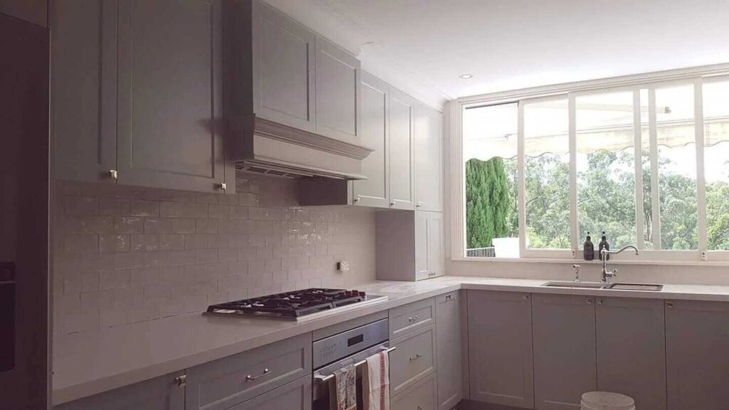 Bright kitchen featuring subway tile backsplash and large windows