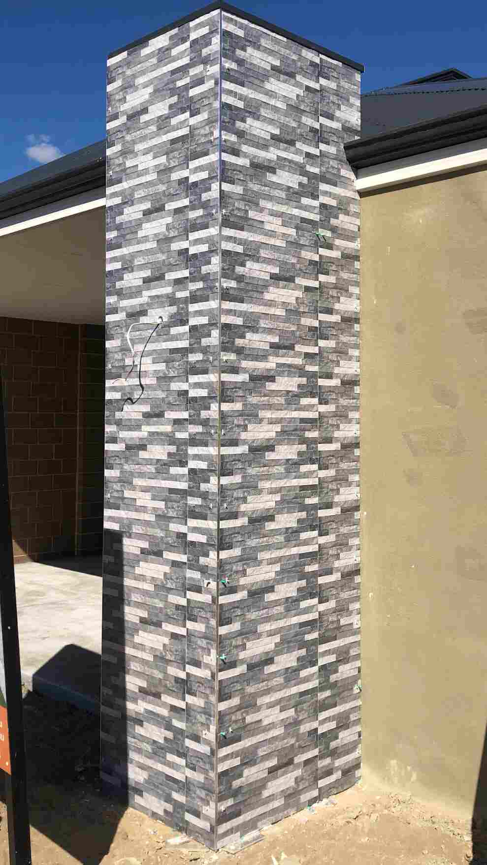 Exterior column covered with grey stone tiles