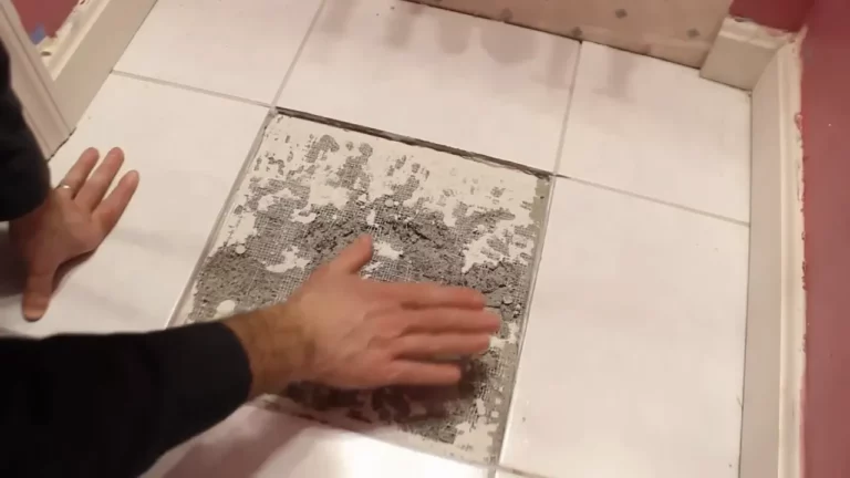 Preparing the surface for tile replacement by removing debris and adhesive.